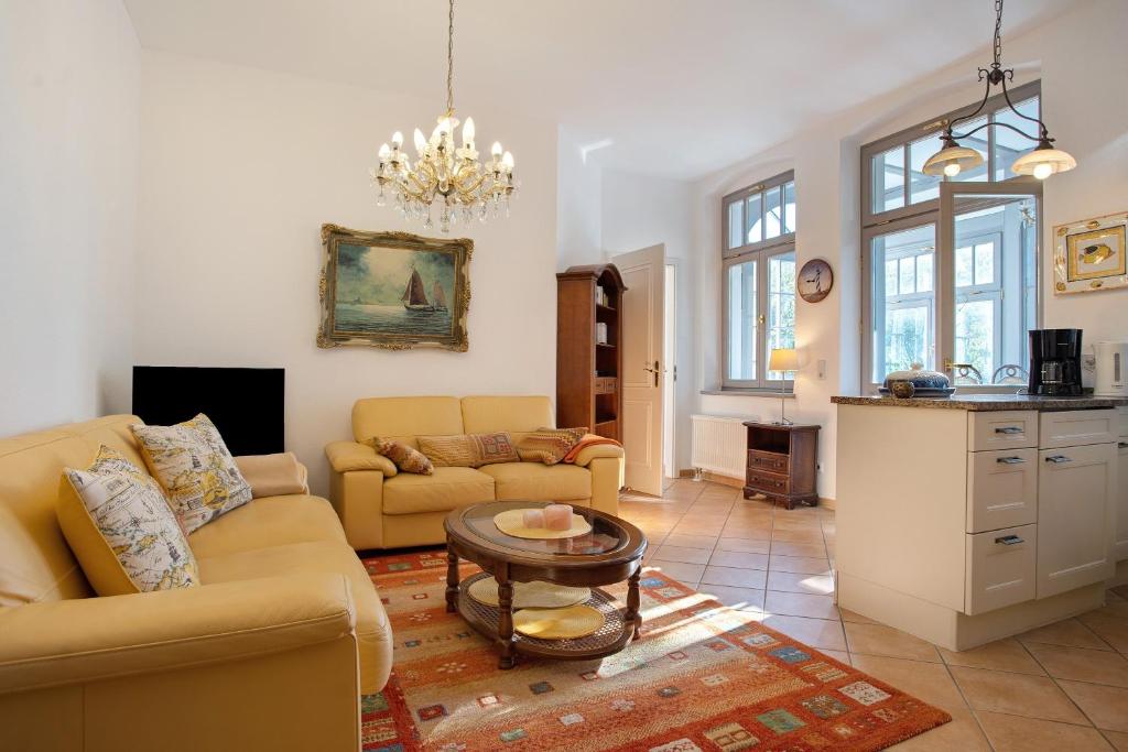 a living room with a couch and a table at Effi-Briest-Villa in Heringsdorf