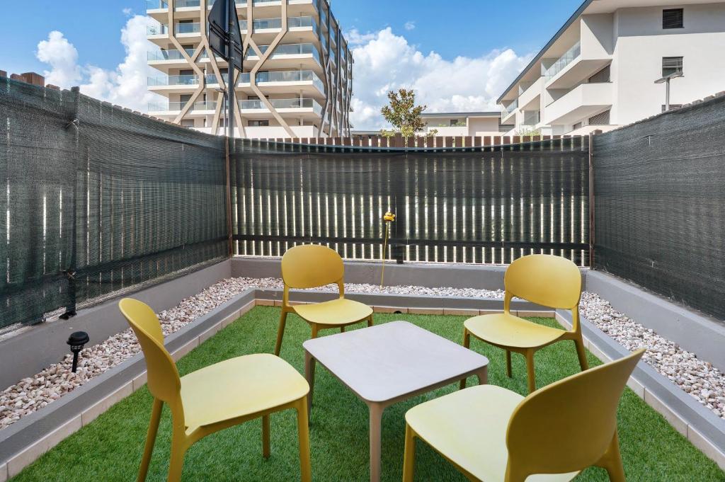 a row of chairs and tables on a rooftop patio at Honey Home With Parking in Laives