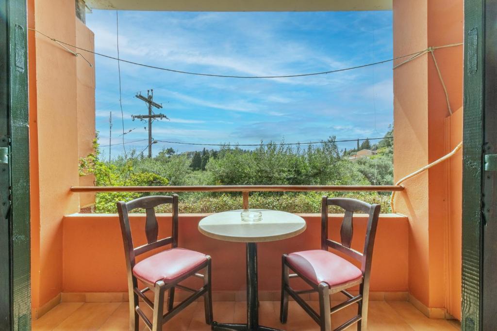 a balcony with a table and two chairs at Arianna Studio Ground Floor 2 in Paleokastritsa