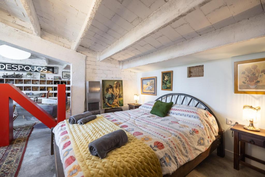 a bedroom with a large bed with pillows on it at La Fabriqueta Apartament Loft in Ríudecañas