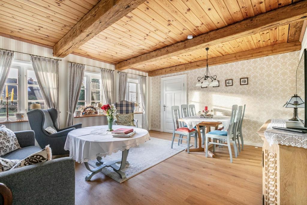 a living room with a table and a dining room at Hof Diederichs in Bohmstedt