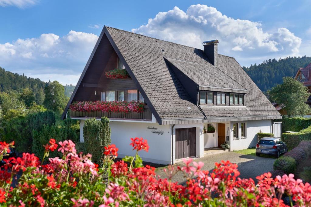 a house with flowers in front of it at Ferienhaus Unmüßig in Hinterzarten
