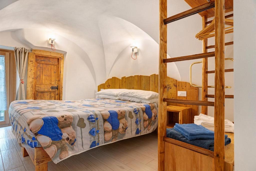 a bedroom with a bunk bed and a ladder at Logge dei Paroloti Paolo in San Lorenzo in Banale