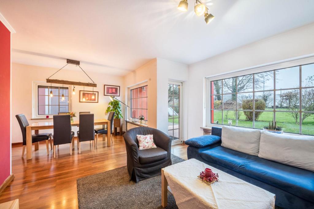 a living room with a blue couch and a table at Haus Rose Muc City in Munich