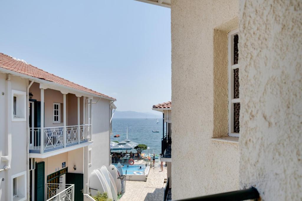 a view of the ocean from the balcony of a building at M3 room in Nikiana