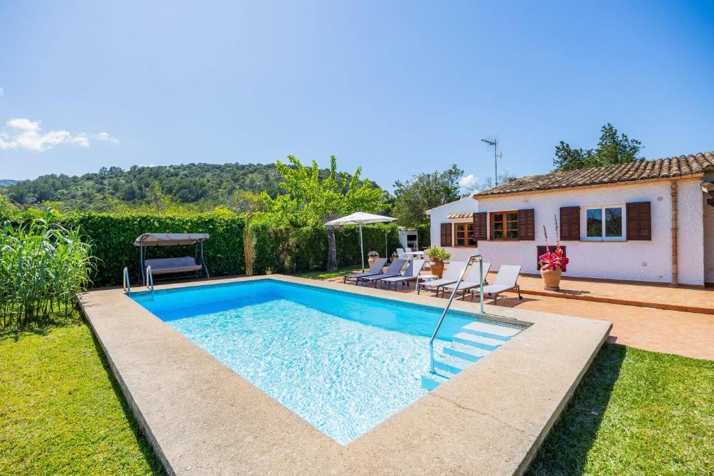a swimming pool in the backyard of a house at Can Amer in Pollença