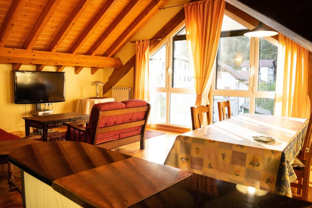a living room with a large window and a television at Kabila Enea 2 in Uztárroz