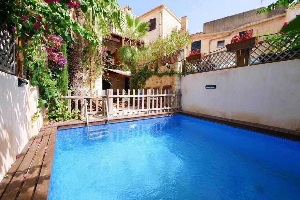 a large blue swimming pool in the middle of a building at Can Teresa in Capdepera