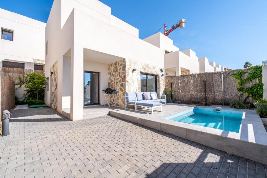 a pool in the backyard of a house at Chalet con Piscina in Orihuela Costa