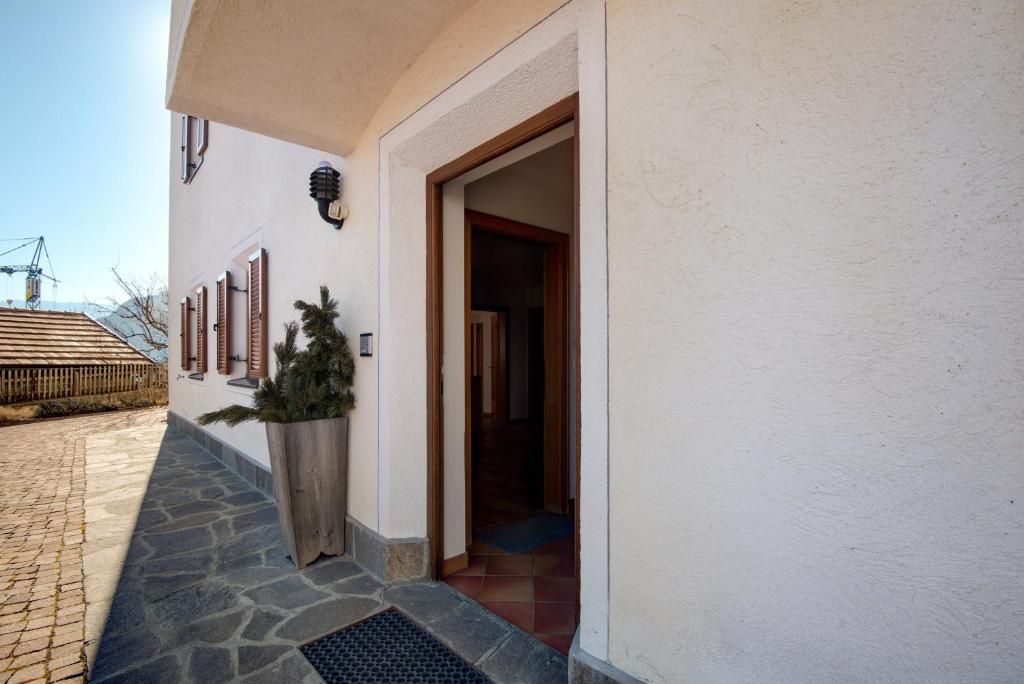 a door to a house with a potted plant in it at Apartment 2 - Zur Sonne in Laion