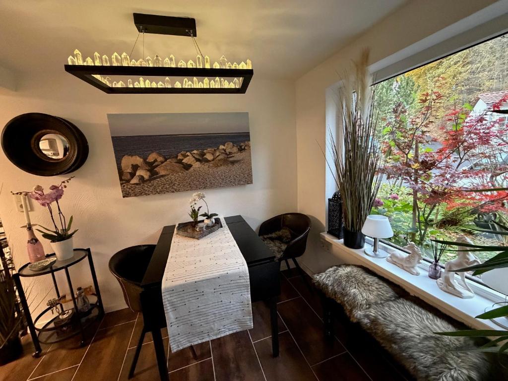 a living room with a table and a large window at Kalles Tochter in Melsungen