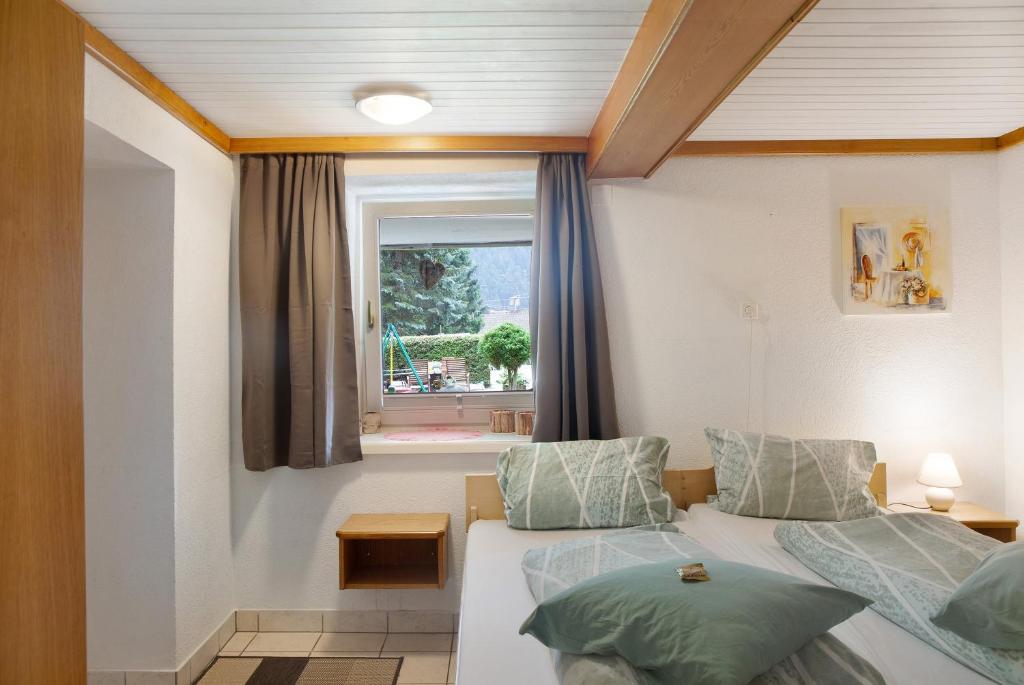a bedroom with two beds and a window at Wasserfall in Stall