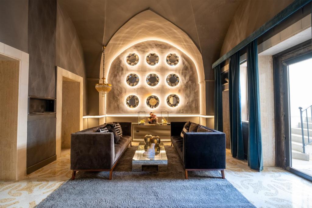 a living room with a couch and a table at Maison boutique At Pietro in San Pietro in Lama