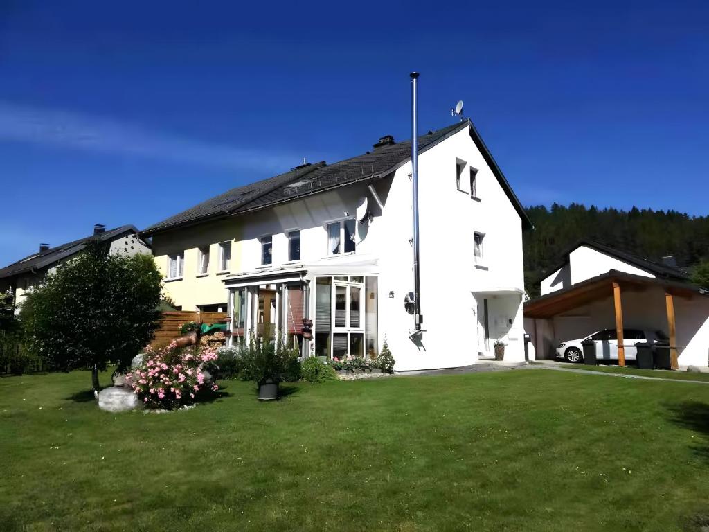 a large white house with a large yard at Fewo Cheny 2 mit 36qm in Titisee-Neustadt