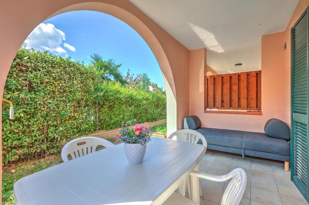 a dining room with a table and a couch at Il Sarago in Marina di Campo