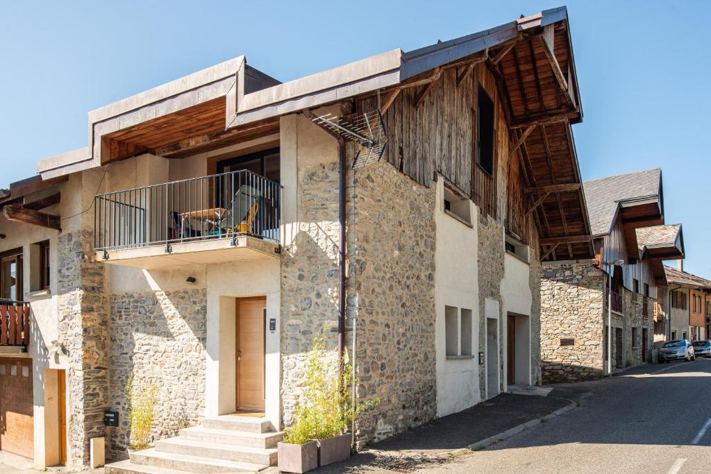 an old building with a dog on a balcony at Chez Flo - clim parking - clg in Saint-Pierre-dʼAlbigny