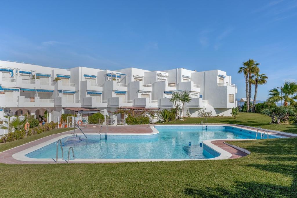 a large white building with a large swimming pool at Brisa y Mar in Calahonda