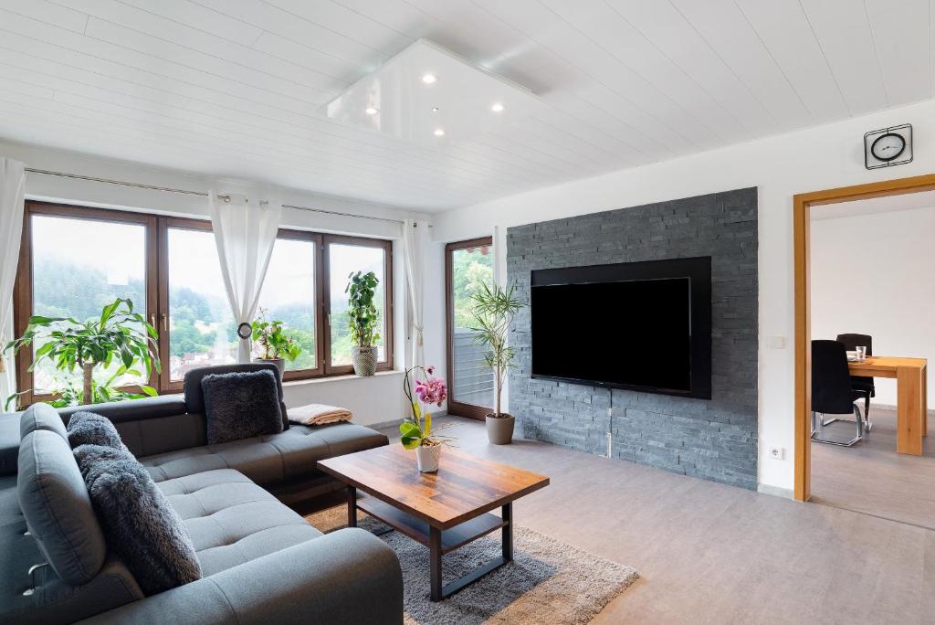 a living room with a couch and a fireplace at Haus Erika Ferienwohnung 1 in Bad Teinach-Zavelstein