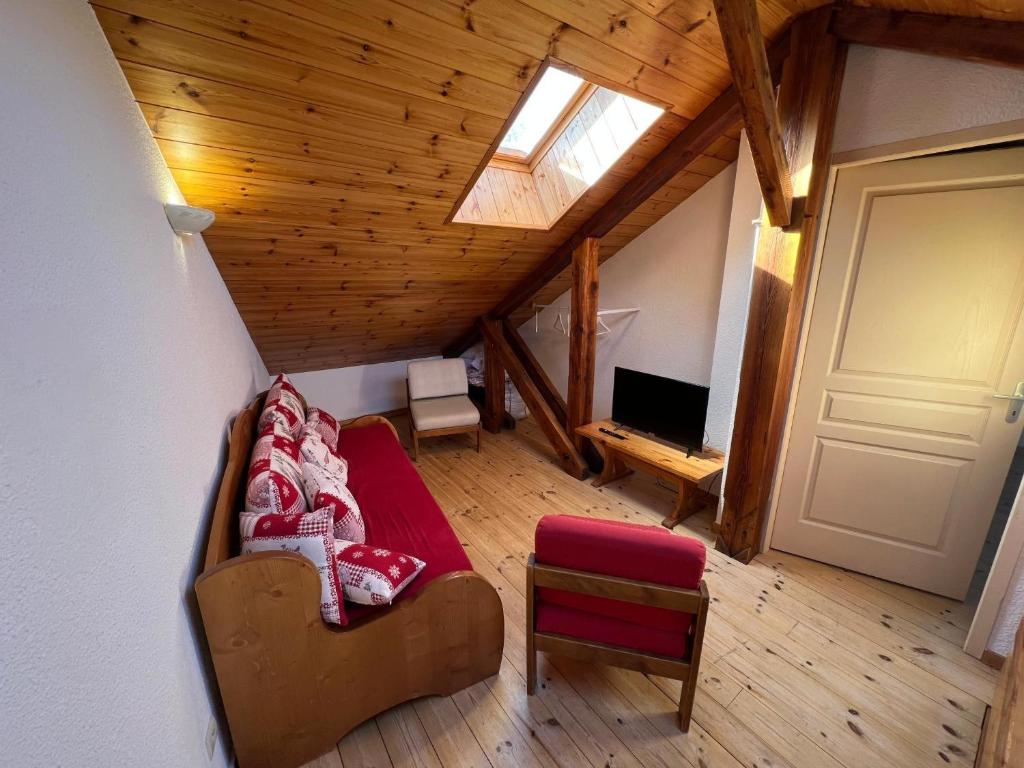 a view of a living room with a couch and a television at Charmant Duplex Pied De Pistes in Briançon