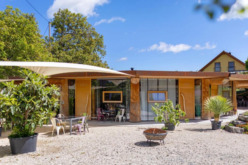 a house with a pavilion with tables and chairs at Albchalet in Rosenfeld