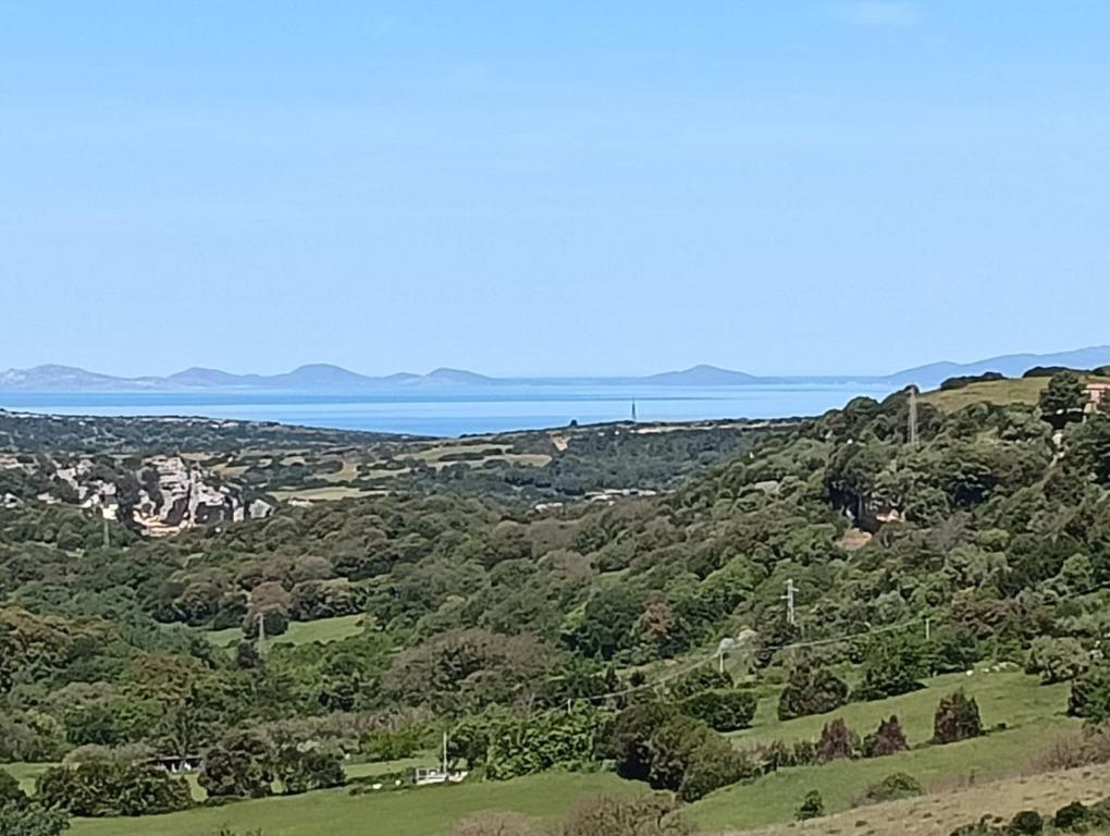 a view of the ocean from the top of a hill at Casa Sonia in Osilo