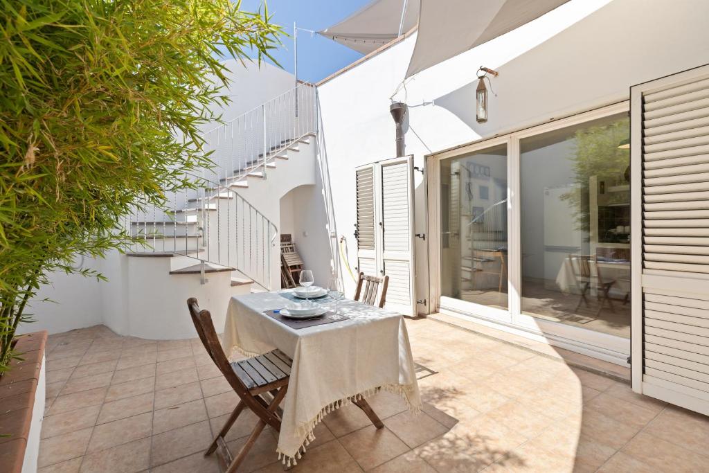a patio with a table and chairs on a patio at I Tre Nuraghi in Tresnuraghes