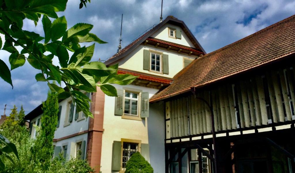 a white house with a brown roof at Villa Buselmeier in Neuried