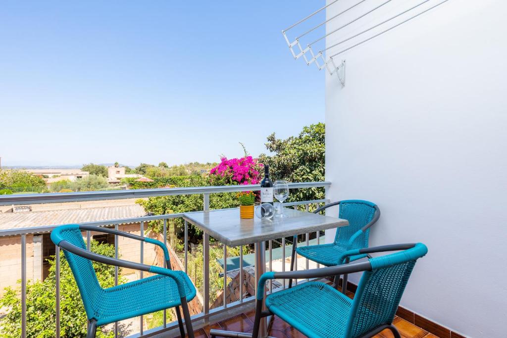 a balcony with a table and three chairs at Apartamento Socorro 39-1 in Felanitx