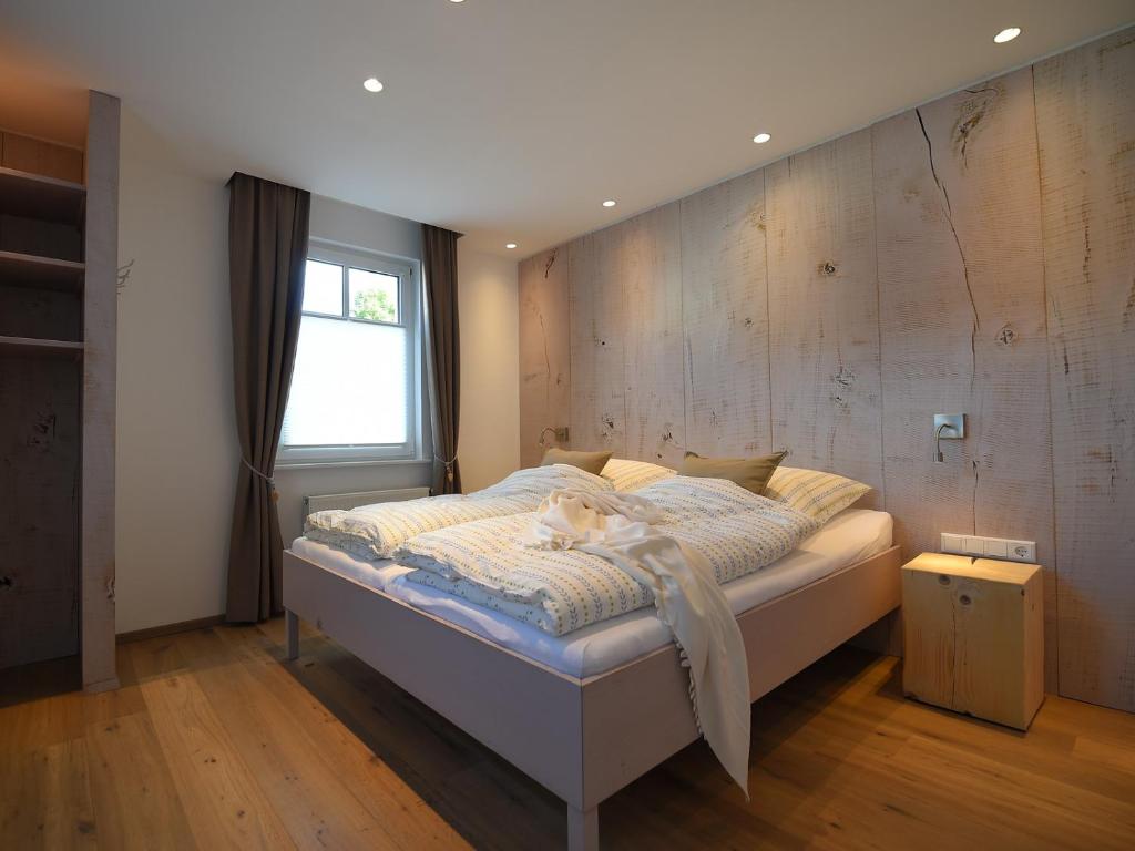 a cat laying on a bed in a bedroom at Ferienwohnung Am Lennepark in Schmallenberg