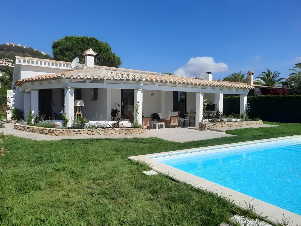 a house with a swimming pool in front of it at Villa Bua in Costa Rei