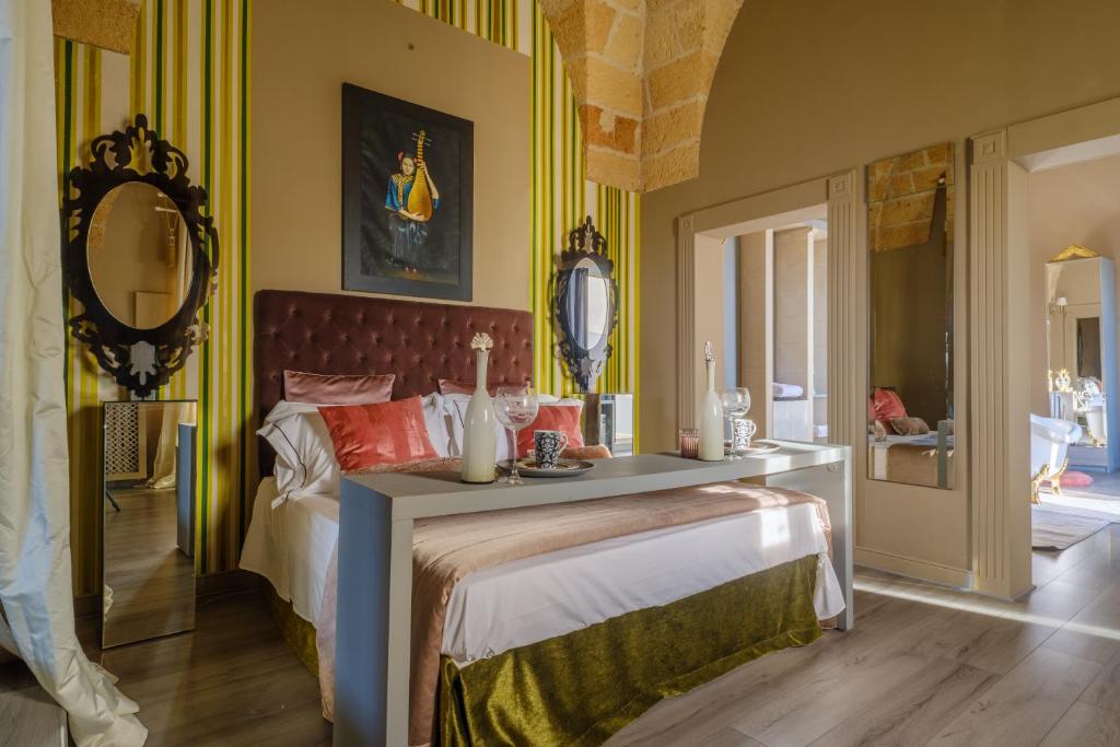 a bedroom with a bed with a table on it at Maison Boutique At Daniela in San Pietro in Lama