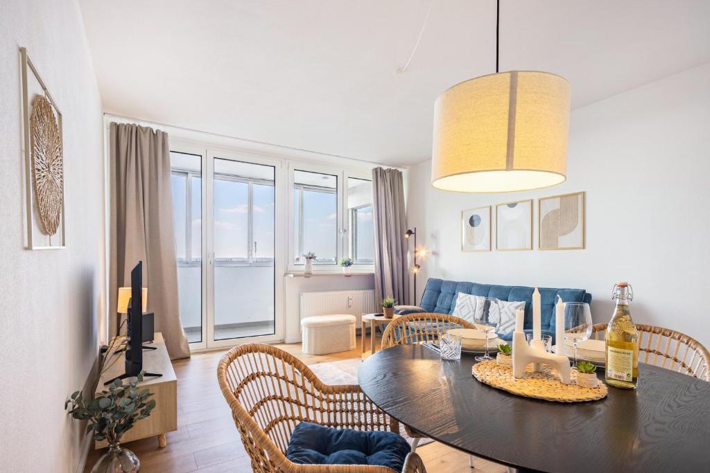 a living room with a table and chairs and a couch at Fewo Sonnenaufgang, Ausblick in Augsburg