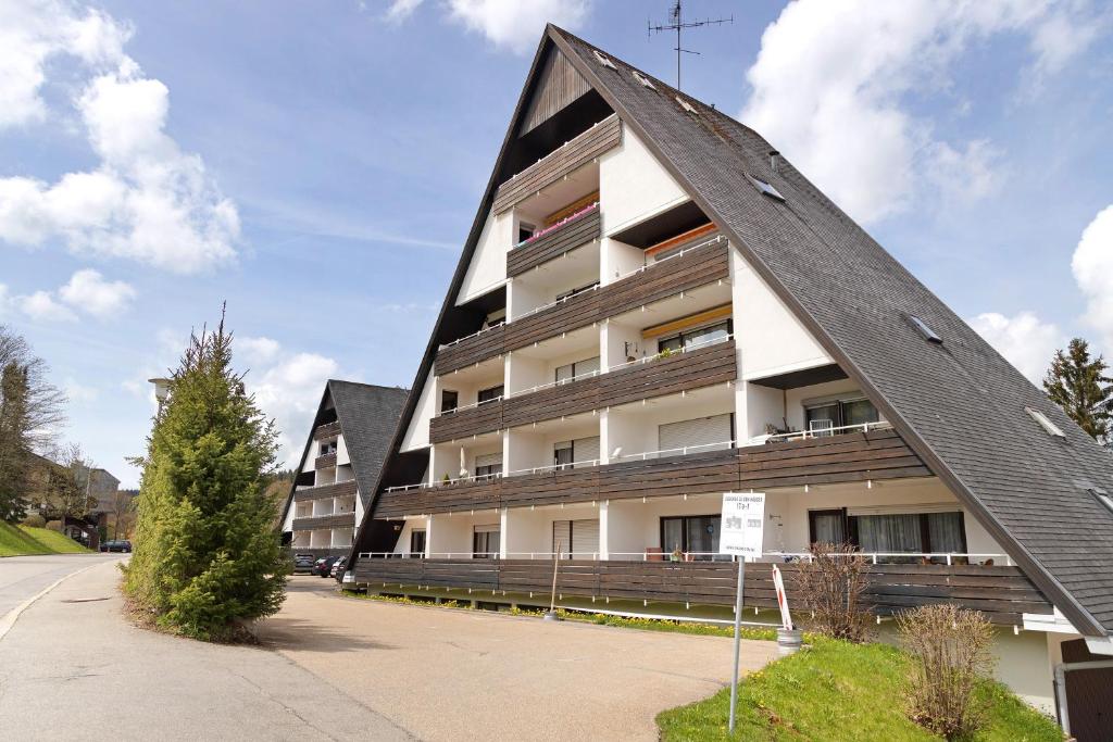 an apartment building with a triangle shaped roof at Isabell in Schönwald