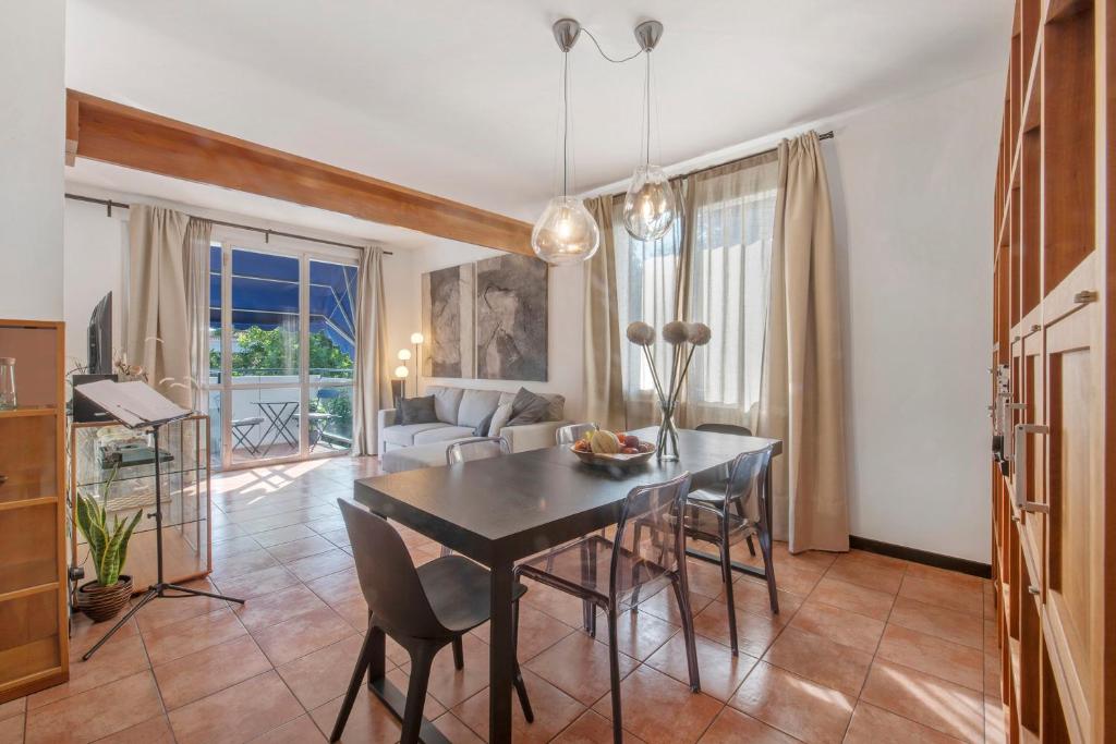 a dining room with a table and chairs and a living room at Lake Como Design Home in Lecco