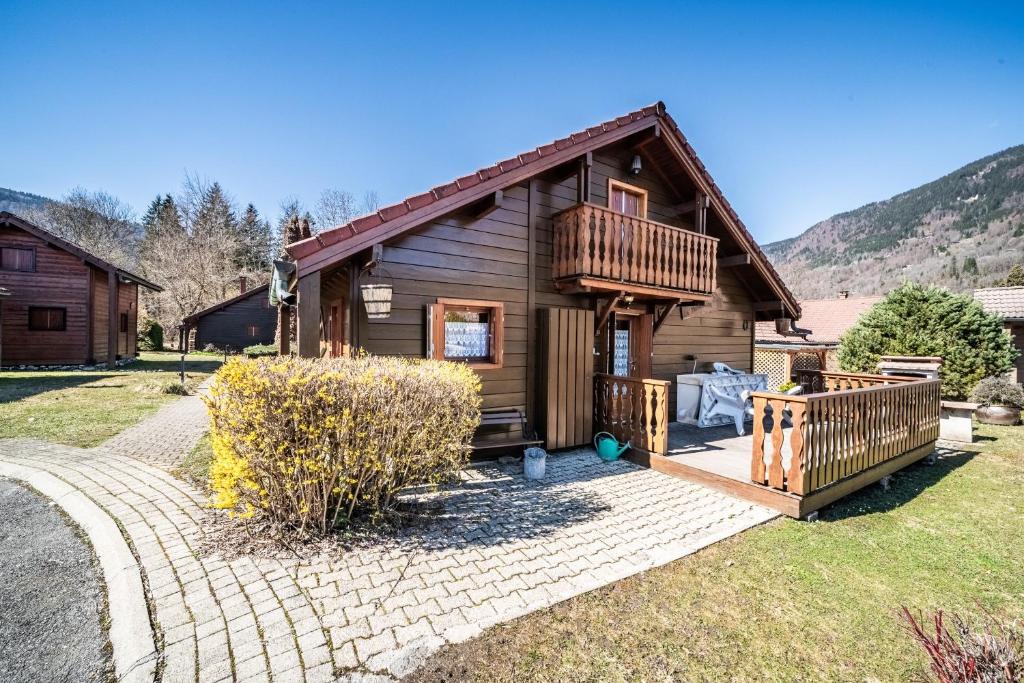 a log cabin with a porch and a deck at Chalet 6p Classique - Le Marmotton in Verchaix