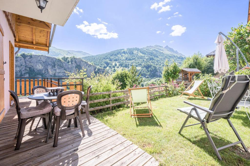 a deck with chairs and a table with a view at La mouliniere 2 in Valloire