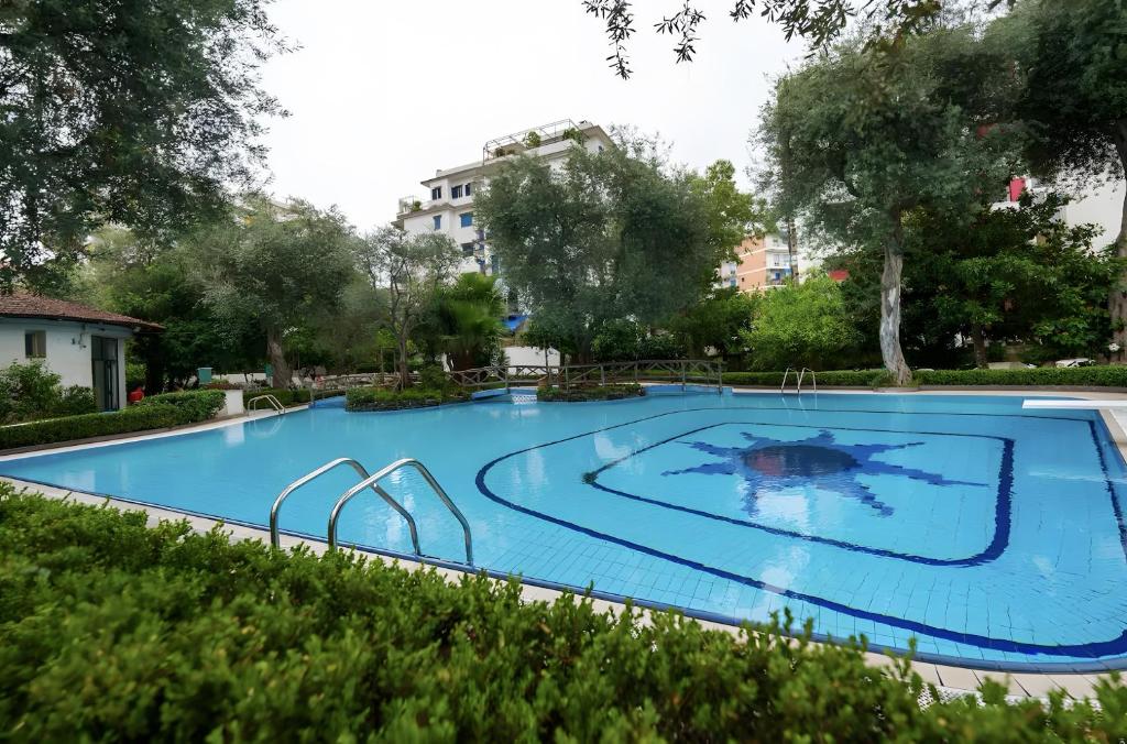 a large swimming pool in a yard with trees at Casa Tina in Sorrento