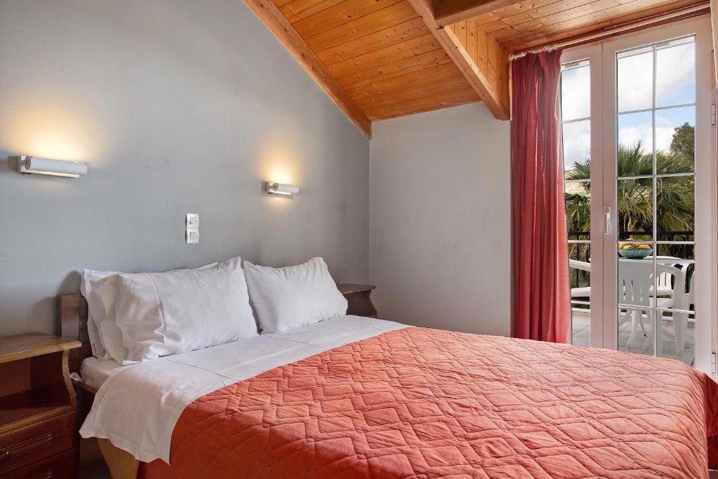 a bedroom with a bed and a large window at Dolphin Apartment Sea View 12 in Keri