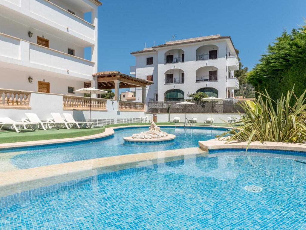 a swimming pool in front of a building at Sa Torre ii in Canyamel