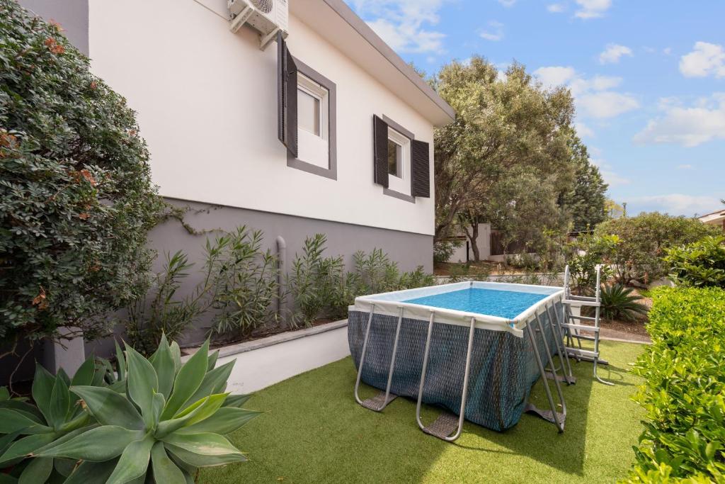 a swimming pool in the backyard of a house at Villa Matteo Suite in Porto Columbu - Perdʼe Sali