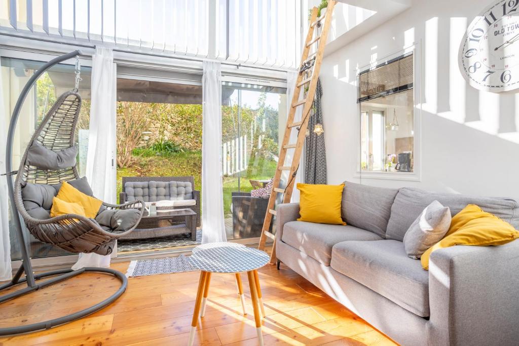 a living room with a couch and a swing at Superbe Duplex en centre ville in Douarnenez