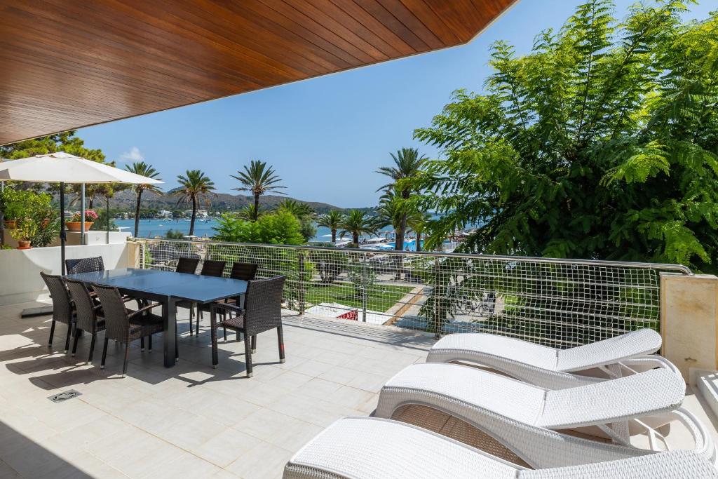 an outdoor patio with a table and chairs at Olympo in Port de Pollensa
