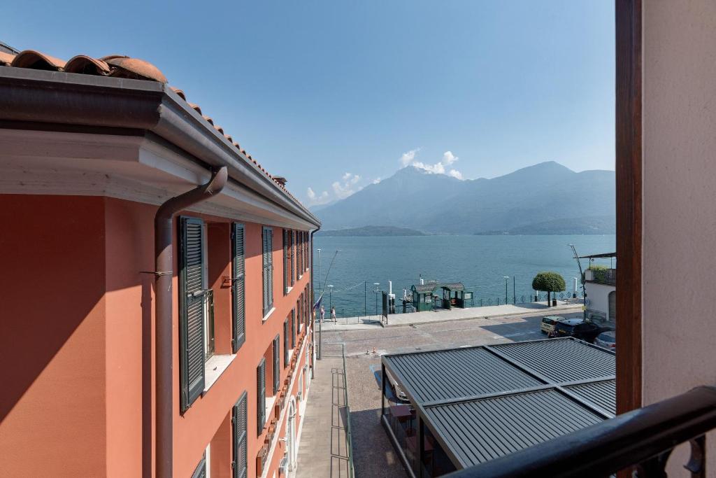a balcony of a building with a view of the water at Very Elegant Historic Apartment F2 in Gravedona