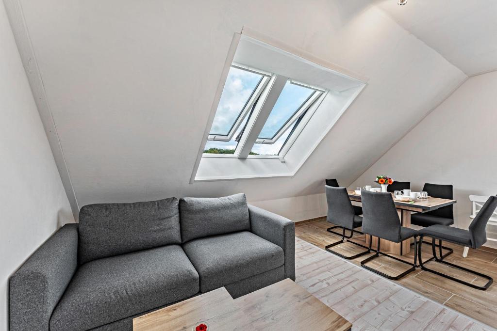 a living room with a couch and a table at Haus Kasberger in Ascheberg