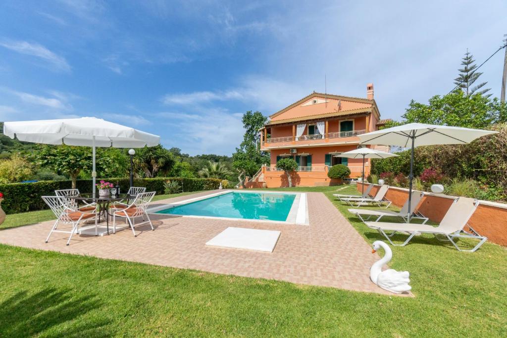 a villa with a swimming pool and a house at Even Ezer with private pool in Pouládes