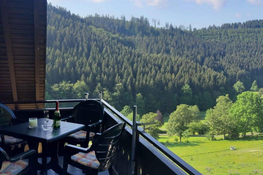 a balcony with a table and a view of a mountain at Ferienwohnung Nordenau in Schmallenberg