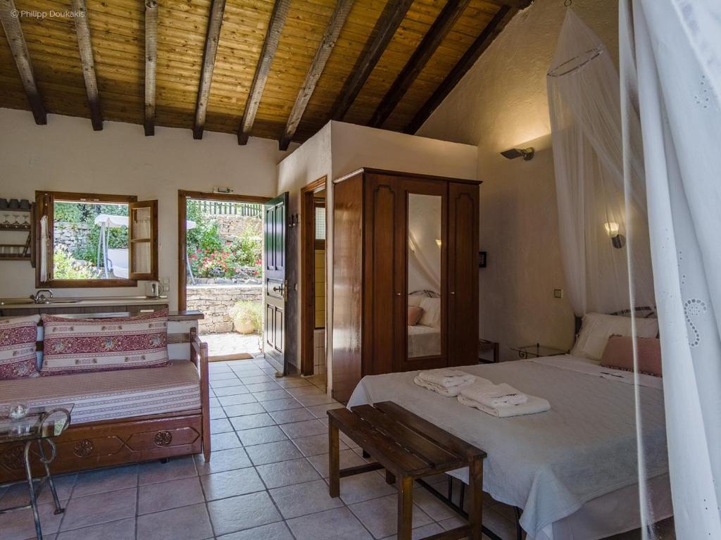 a bedroom with a bed and a bench in it at Adamantia Studio S1 in Gaios