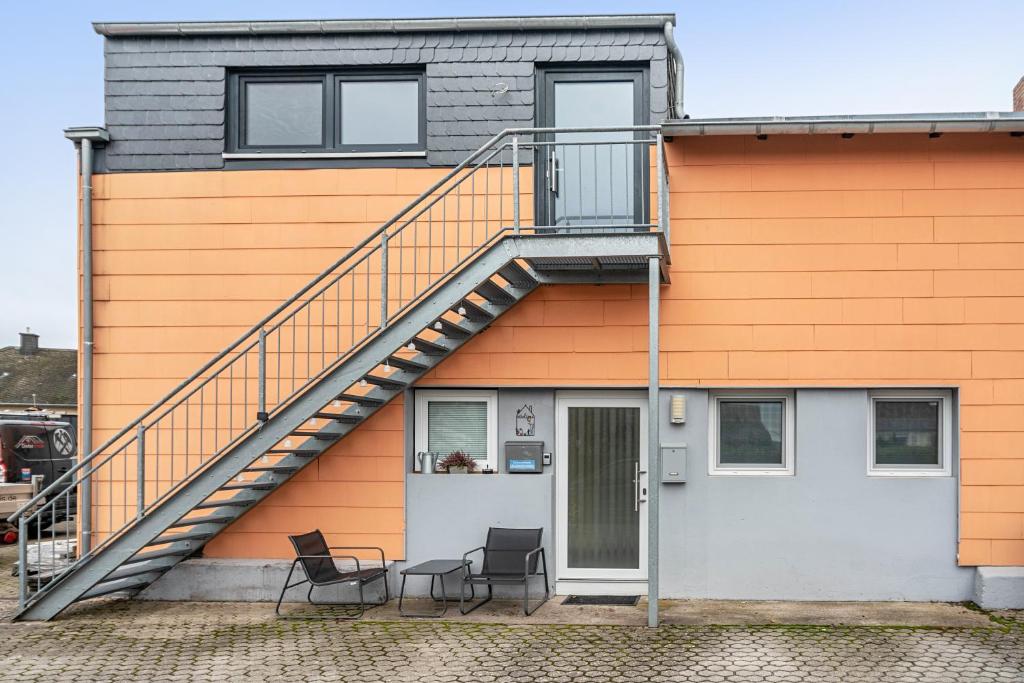 a house with a staircase on the side of it at Tor zum Hochwald in Thomm