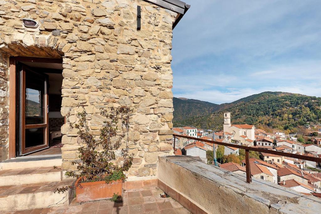 a building with a balcony with a view of a city at The Gallery - Unità 16 in Baiardo