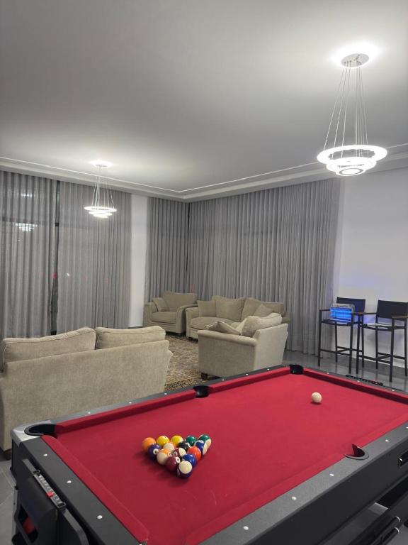 a living room with a red pool table at Al REEF in Billah